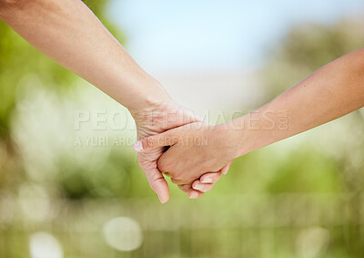 Buy stock photo Cropped shot of a woman holding her son's hand while walking outside