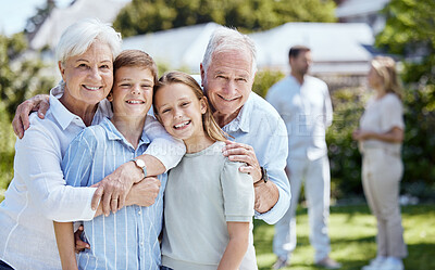 Buy stock photo Shot of a senior couple standing outside with their two grandchildren