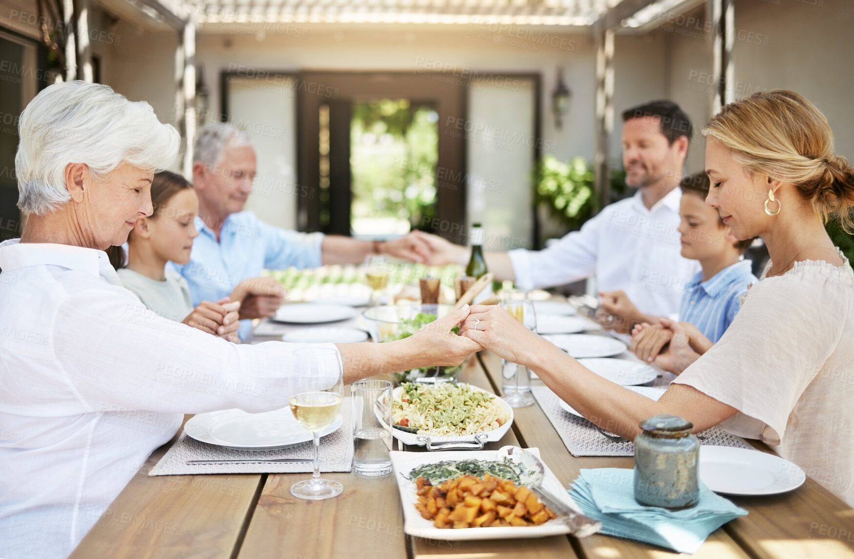 Buy stock photo Family generations, holding hands and pray for lunch, thanksgiving or people celebrate holiday at home. Grace, mother and father with kids or grandparents blessing food for gratitude at dinner table