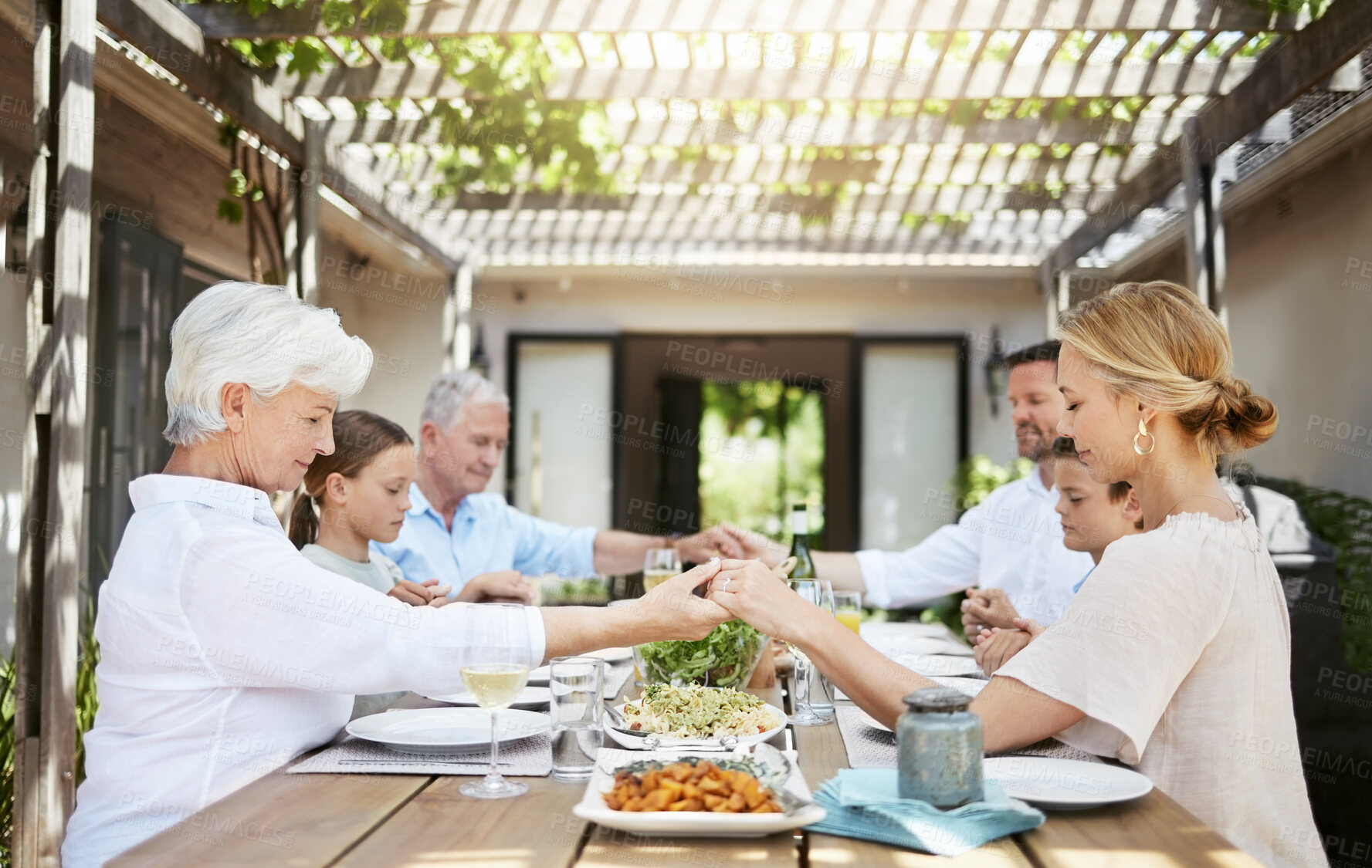 Buy stock photo Family generations, holding hands and pray for food, thanksgiving or people celebrate holiday at home. Grace, mother and father with kids or grandparents blessing lunch for gratitude at dinner table