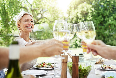 Buy stock photo Shot of a family sharing a toast while enjoying a meal together