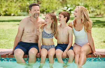 Buy stock photo Shot of a couple and their two children spending time by the pool