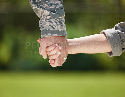 Buy stock photo Holding hands, soldier and closeup of family, love and bonding with child, reunion or return from military. Support, uniform and person with kid, nature and care of veteran, youth or father from army