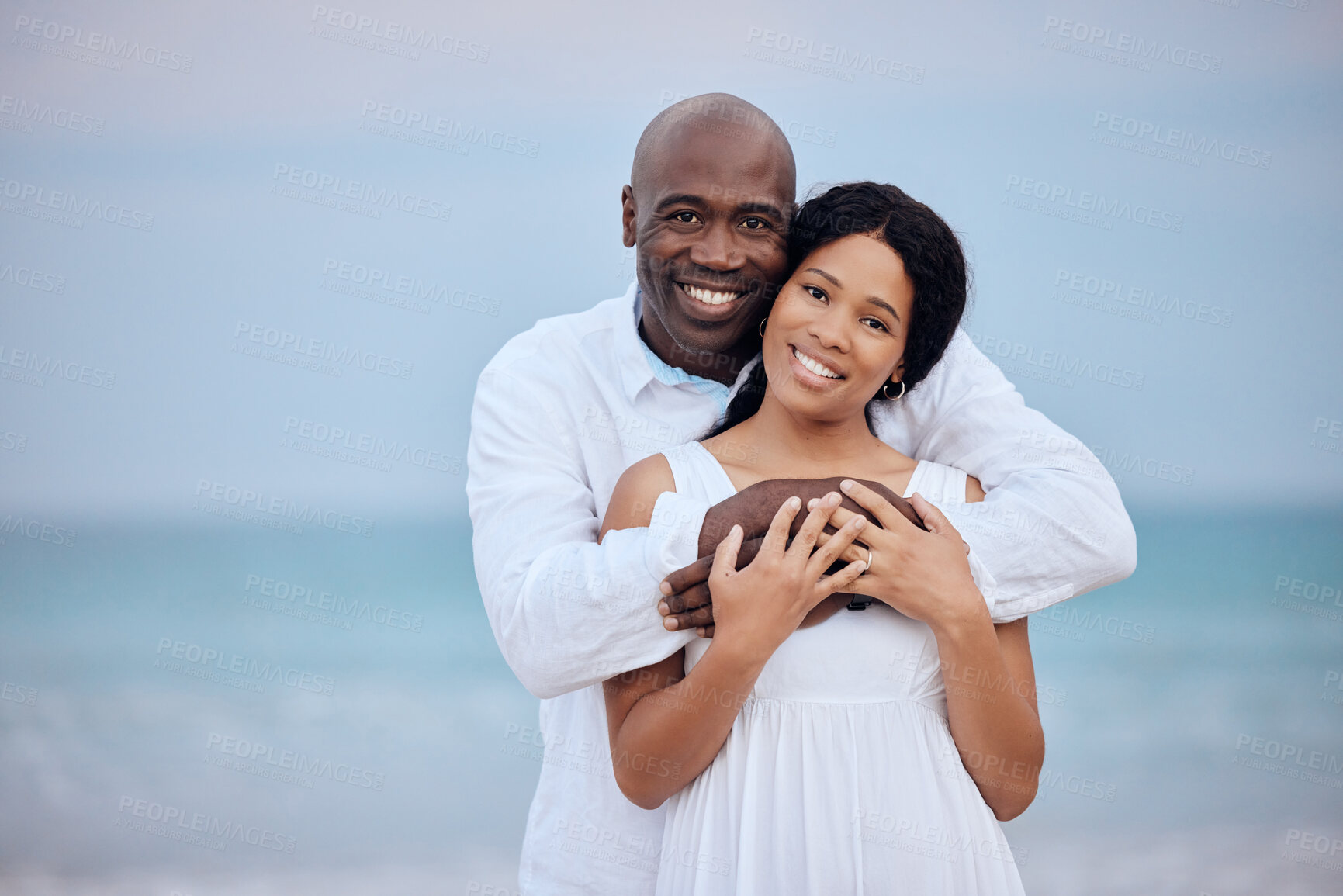 Buy stock photo Hug, honeymoon and black couple in portrait at beach for love, trust or travel together on date. Smile, sea or happy people romantic anniversary for holiday, trip or marriage commitment in Mauritius