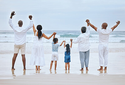 Buy stock photo Rearview shot of a family spending the day at the beach together