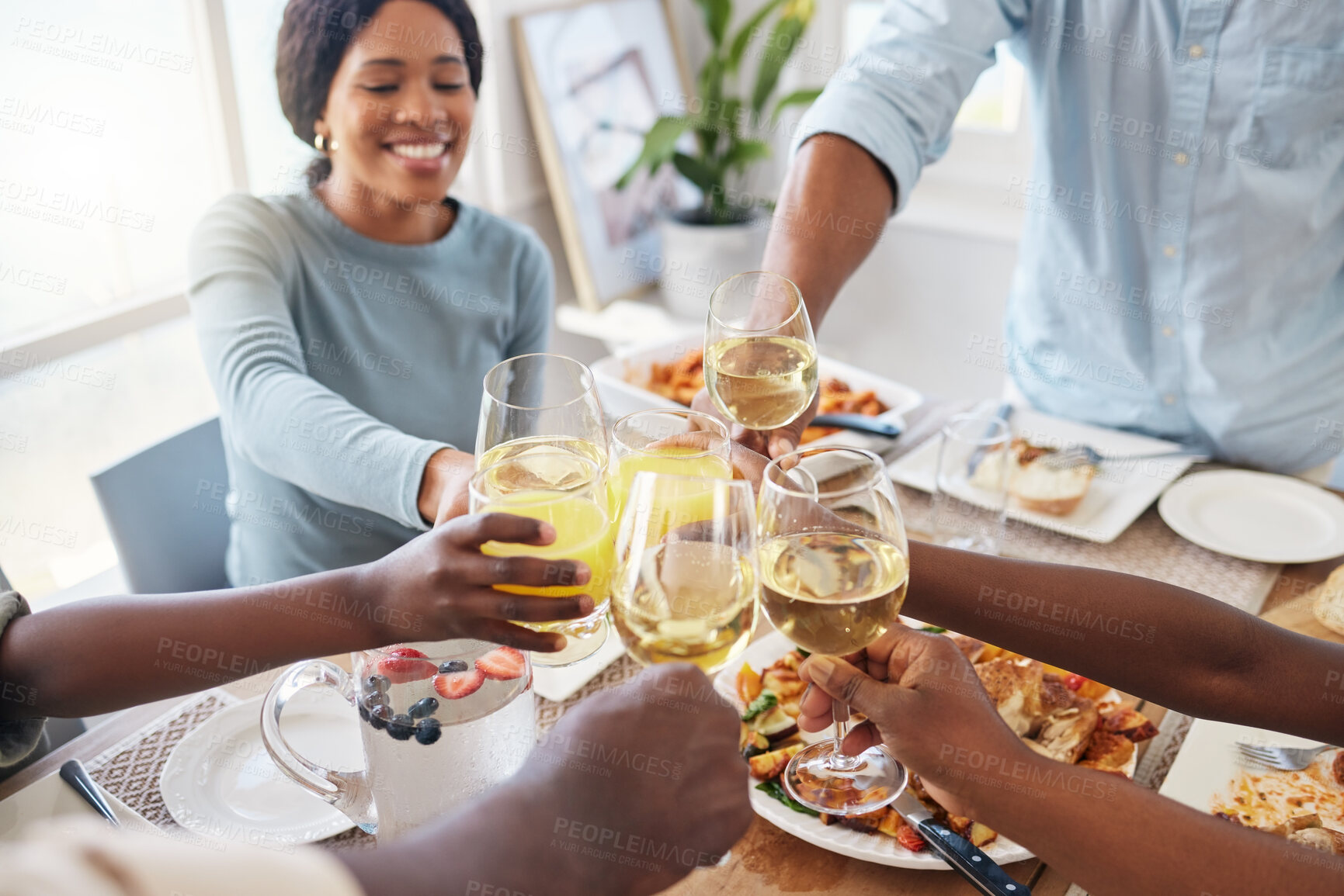 Buy stock photo Hands of family, food or toast with glasses for meal, dining or thanks giving dinner with drinks. Top view, parents or kids in home for bonding, event or feast together on holiday, weekend or lunch