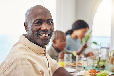 Buy stock photo Shot of a man having lunch with his family
