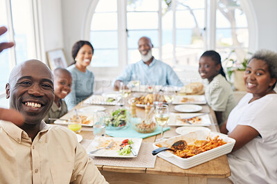 Buy stock photo Shot of a family taking a selfie while having lunch at home