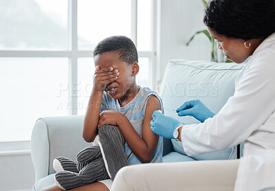 Buy stock photo Shot of a little boy looking scared while getting an injection on his arm from a doctor