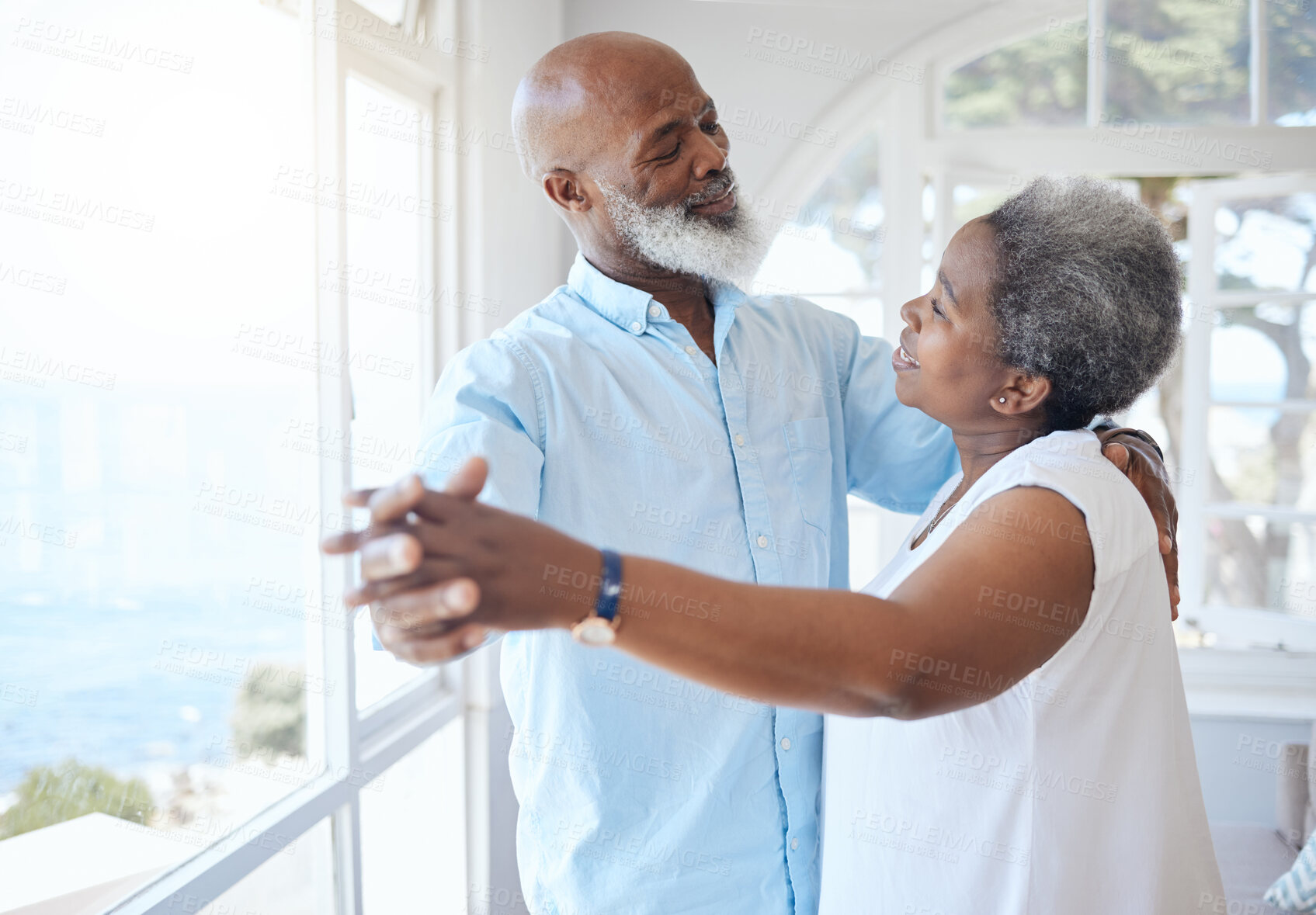 Buy stock photo Black couple, dancing and together in senior home with love, care and commitment. Happy african man and woman relax and dance to enjoy marriage, retirement and happiness while holding hands