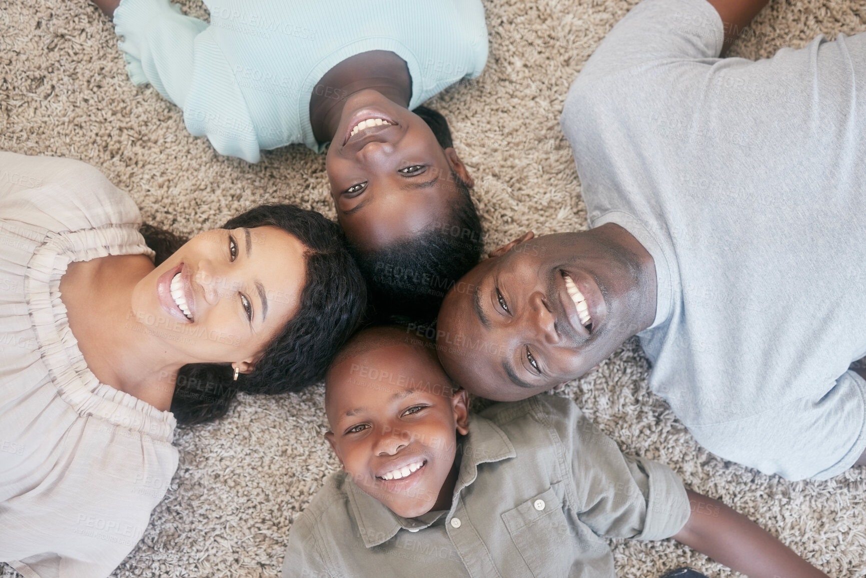 Buy stock photo Shot of a family laying on the floor at home