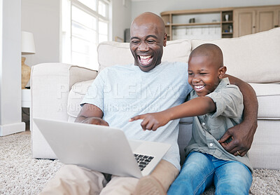 Buy stock photo Shot of a father and son using a laptop on the sofa at home