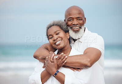 Buy stock photo Hug, portrait and a senior couple at the beach for a vacation, retirement travel and walking. Smile, love and an elderly man and woman hugging with affection on a date by the ocean in Portugal