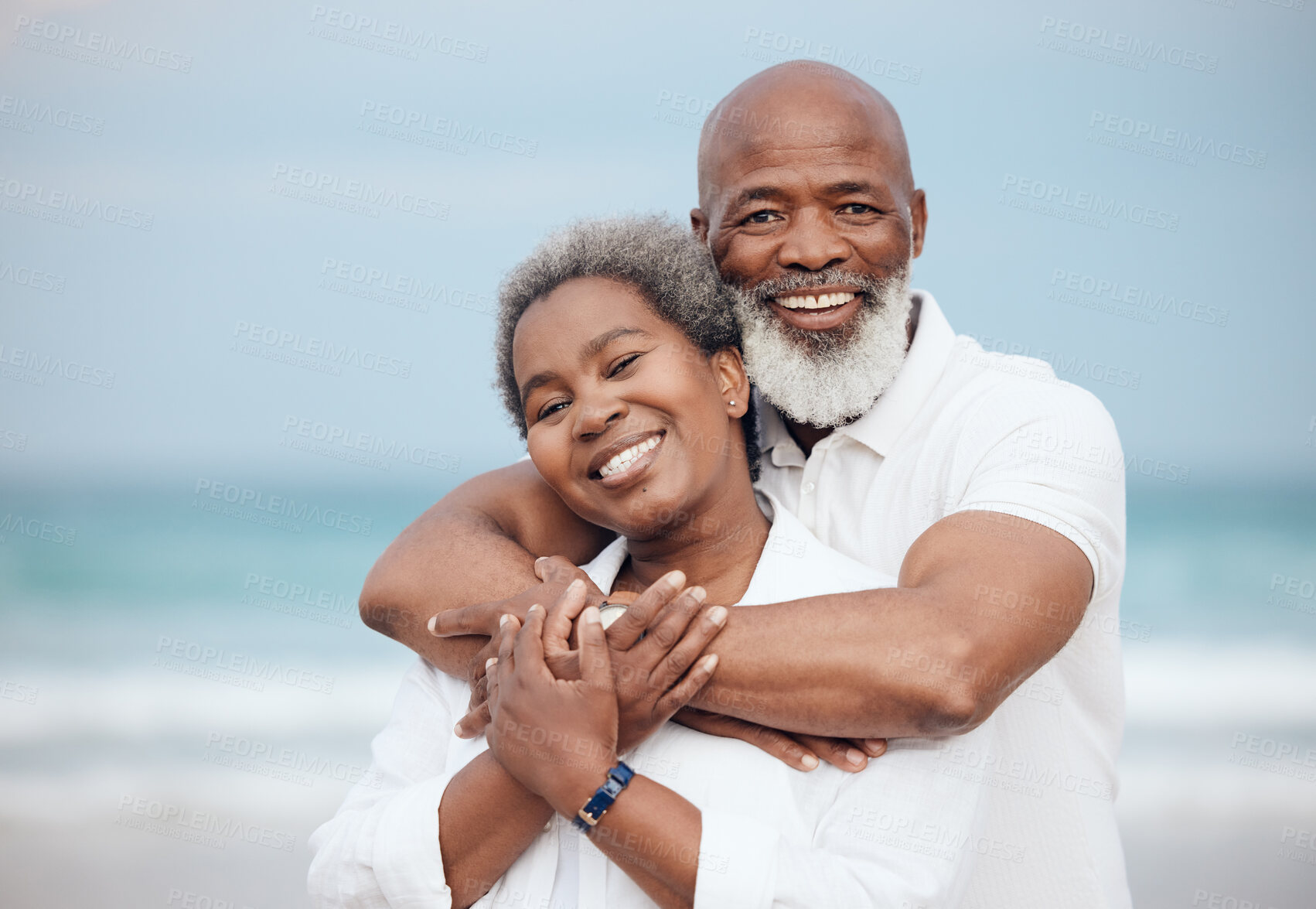 Buy stock photo Hug, portrait and a senior couple at the beach for a vacation, retirement travel and walking. Smile, love and an elderly man and woman hugging with affection on a date by the ocean in Portugal