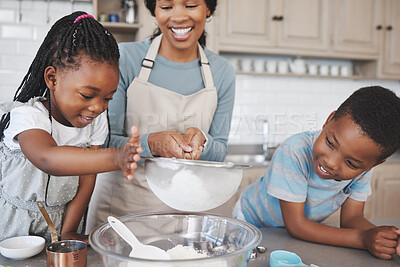Buy stock photo Shot of a mother baking with her children at home