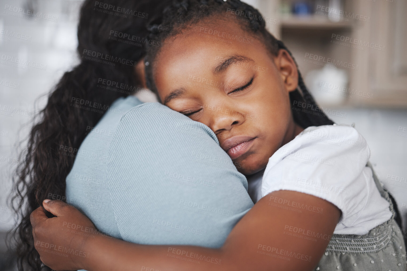 Buy stock photo Shot of a young mother holding her daughter at home