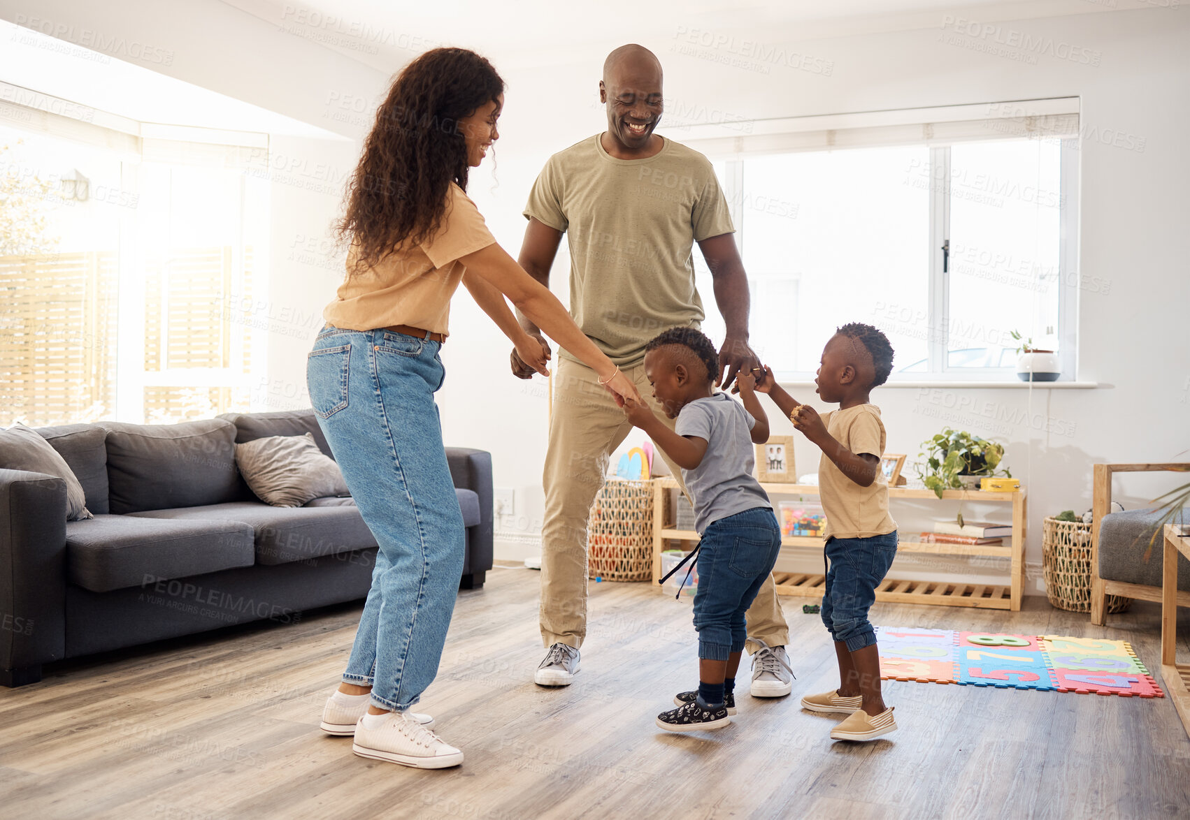 Buy stock photo Shot of a young family spending time together at home