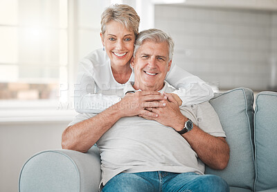 Buy stock photo Hug, senior couple and portrait on couch with love, connection and bonding together in marriage. House, woman and man on sofa in retirement, commitment and security and embrace support in home