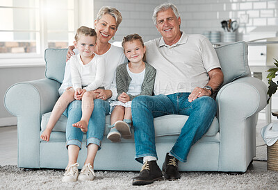Buy stock photo Shot of a happy senior couple and their granddaughters  relaxing on the sofa at home