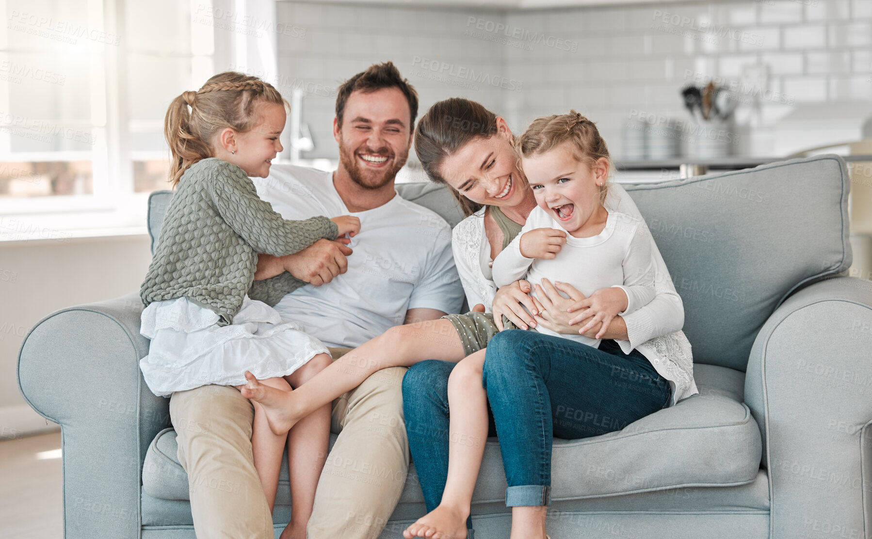 Buy stock photo Family, bonding and laughing in house for relax, care and happiness on sofa with joy, embrace and fun. Parents, face and people with children for love, playful and support together in lounge on couch