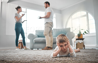 Buy stock photo Shot of a little boy looking sad while his parent argue at home