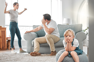 Buy stock photo Shot of a little girl looking sad while her parent argue at home