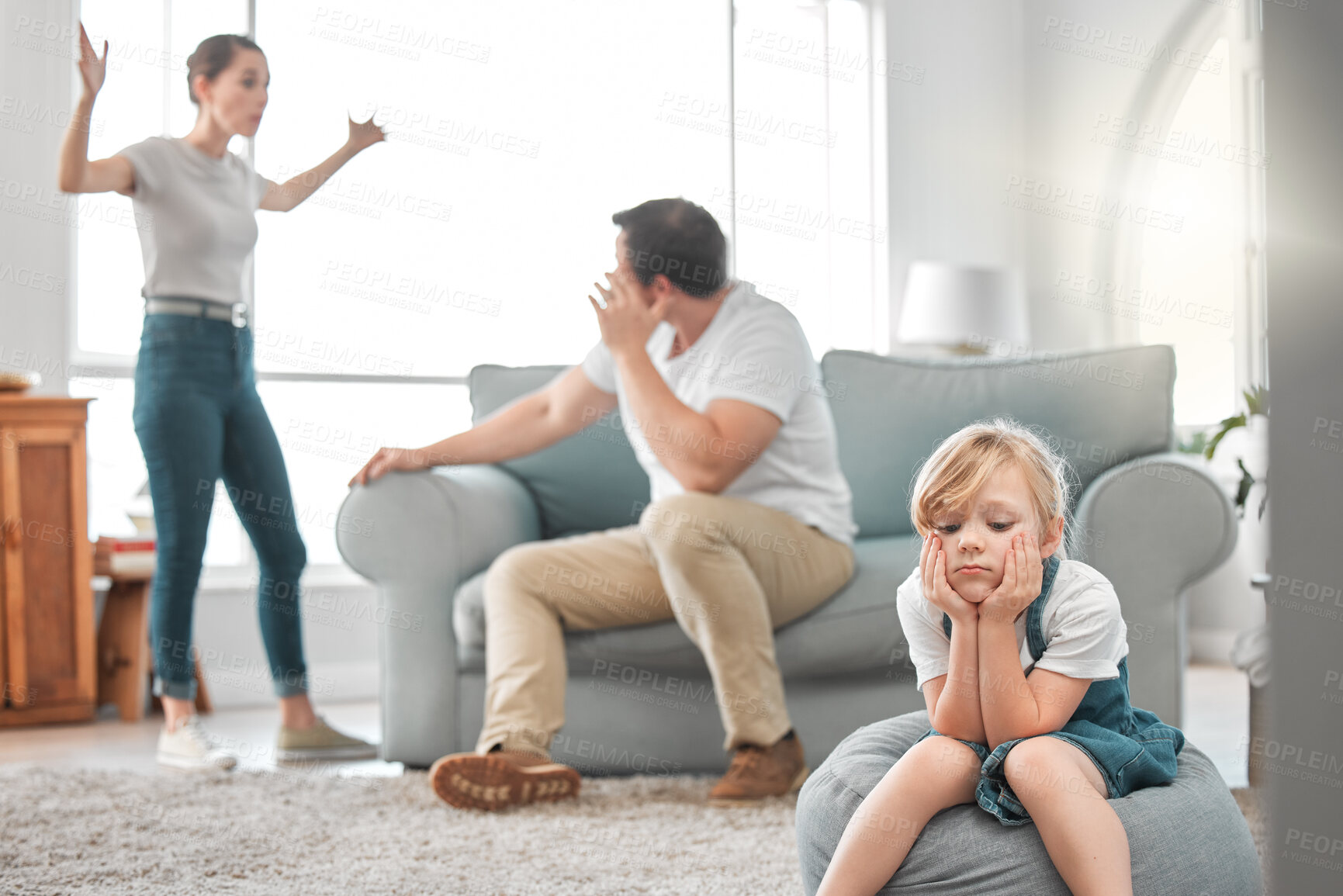 Buy stock photo Shot of a little girl looking sad while her parent argue at home