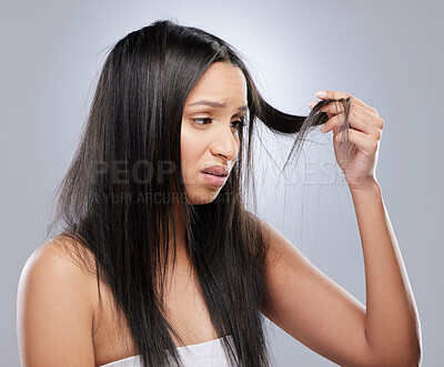 Buy stock photo Hair, worry and woman with crisis in studio for split ends, haircare crisis and weak tips on gray background. Beauty, salon and face of upset female person with frizz, dry texture and loss problem