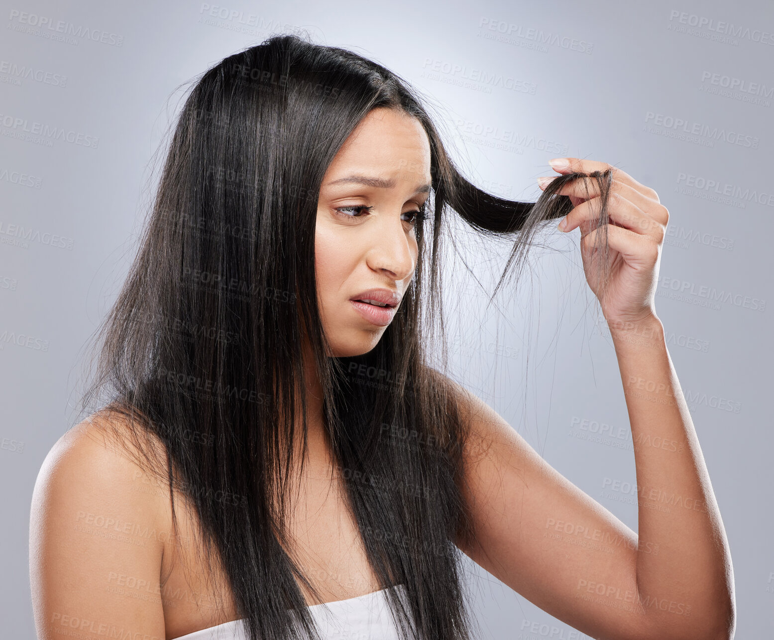 Buy stock photo Hair, worry and woman with crisis in studio for split ends, haircare crisis and weak tips on gray background. Beauty, salon and face of upset female person with frizz, dry texture and loss problem