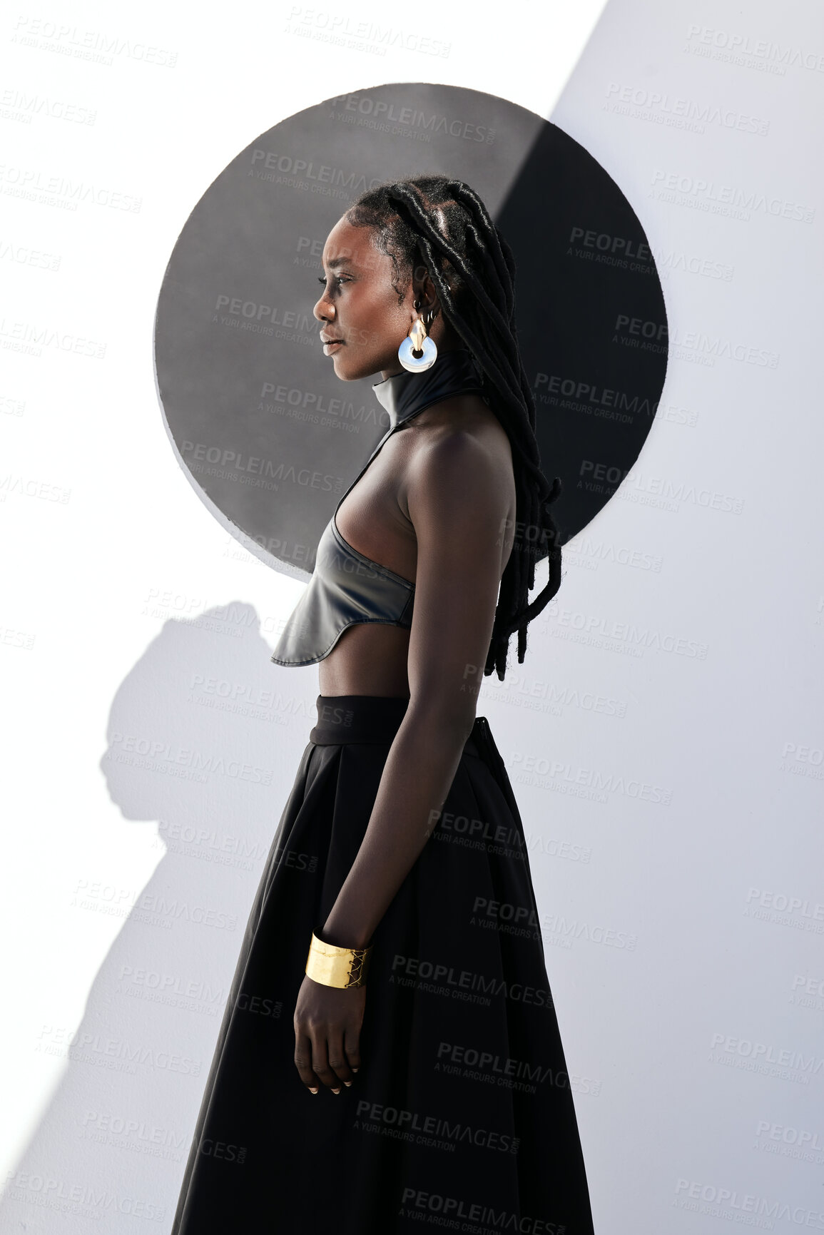 Buy stock photo Black woman, fashion and circle with dress in studio for african culture, style or tradition. Female person, outfit or stylish designer with fierce clothing or shape for beauty on a wall background
