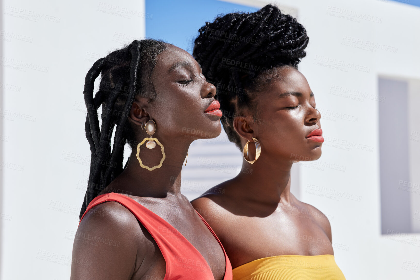 Buy stock photo Cropped shot of two attractive young women posing on a rooftop outdoors