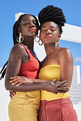 Buy stock photo Cropped shot of two attractive young women posing on a rooftop outdoors