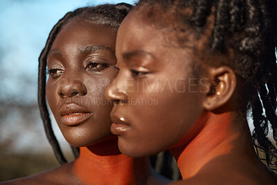 Buy stock photo Shot of two beautiful tribal women posing outside together