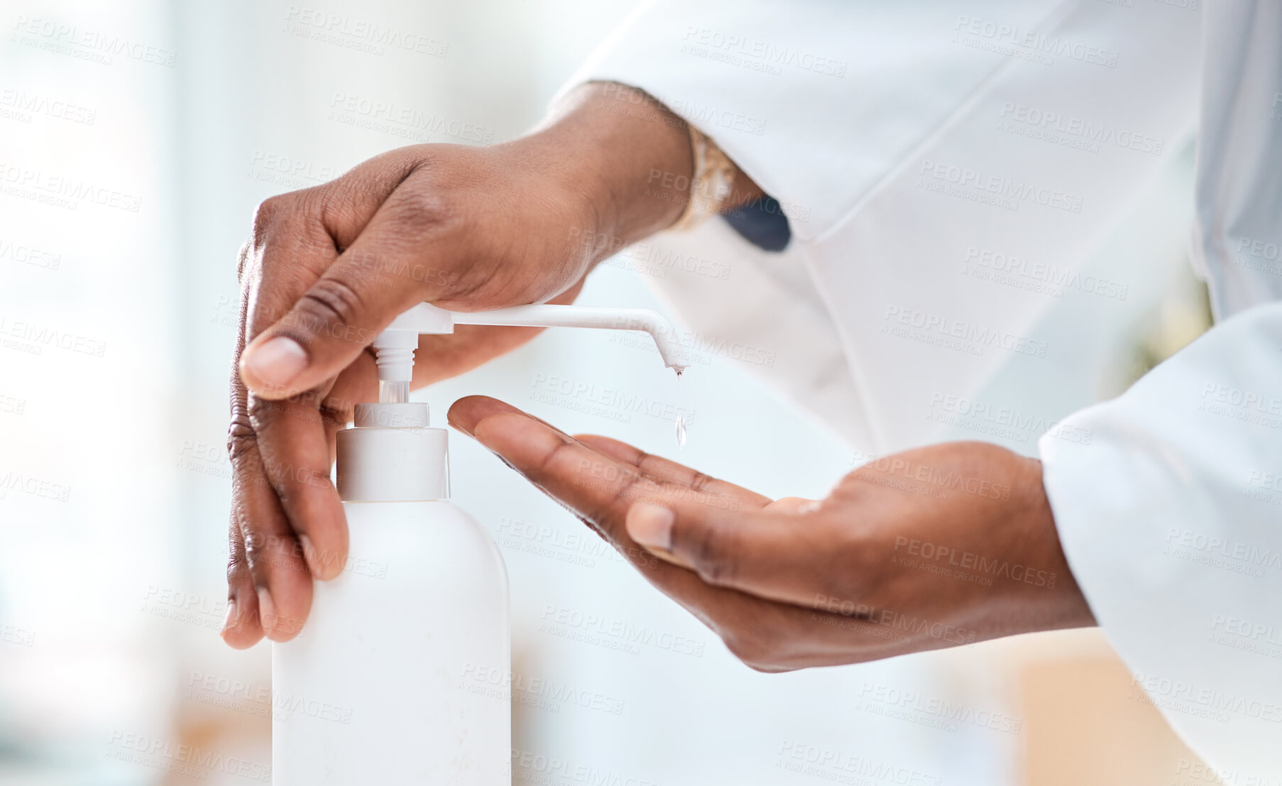 Buy stock photo Closeup shot of an unrecognisable doctor using hand sanitiser in a clinic