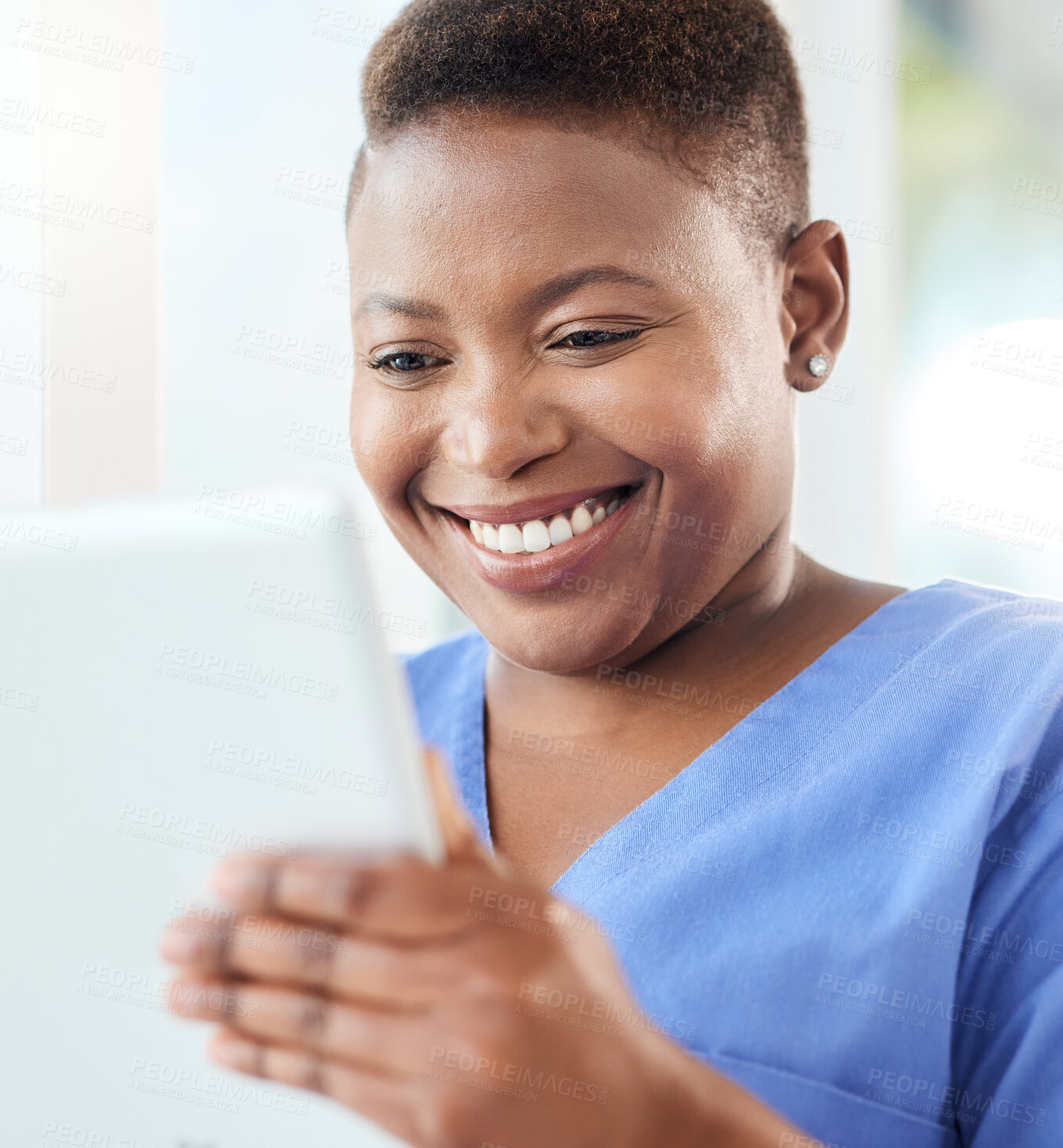 Buy stock photo Shot of a young nurse using a tablet in a office