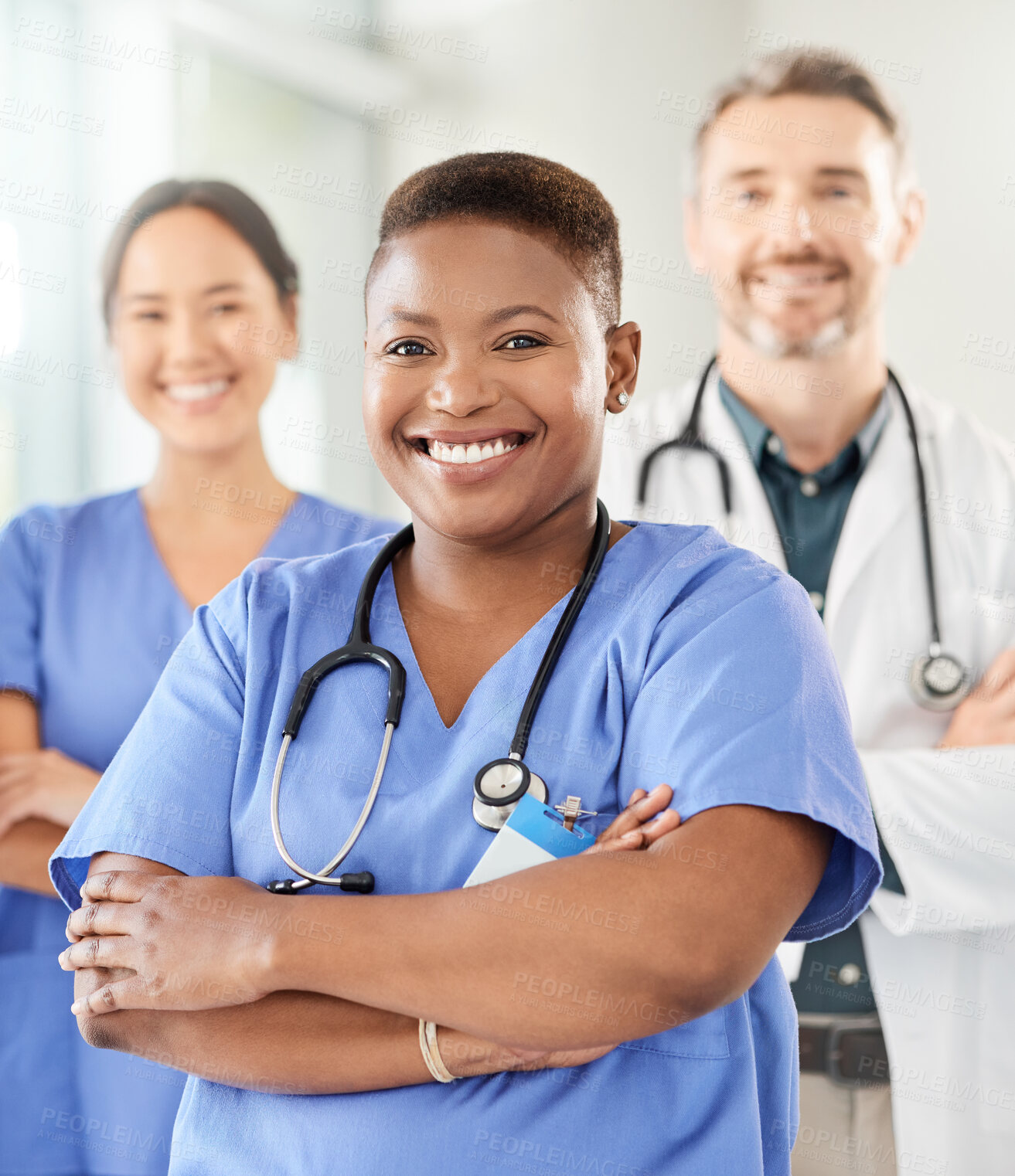 Buy stock photo Shot of a group of medical practitioners standing together in a hospital