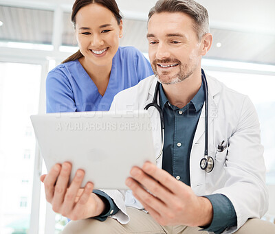 Buy stock photo Shot of two doctors using a tablet in a office