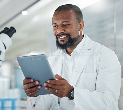 Buy stock photo Shot of a male scientist using a digital tablet while working in a lab