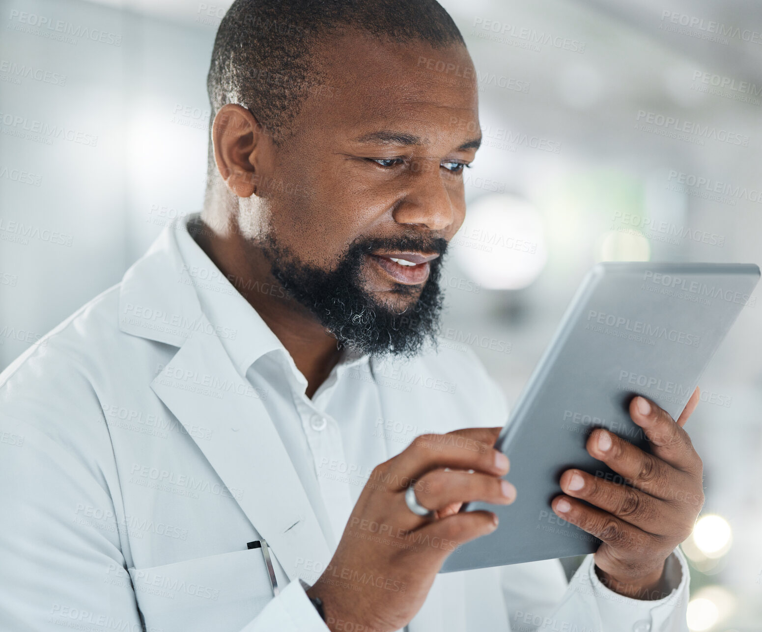 Buy stock photo Shot of a male scientist using a digital tablet while working in a lab