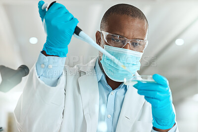 Buy stock photo Shot of a mature scientist sitting alone in his laboratory and testing urine