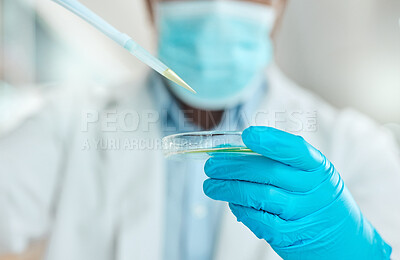Buy stock photo Cropped shot of an unrecognisable scientist holding a petri dish and using a dropper in the laboratory