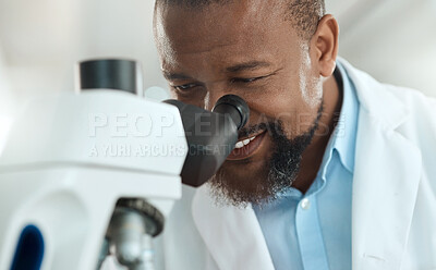 Buy stock photo Shot of a handsome mature scientist using a microscope to analyse a sample in the laboratory