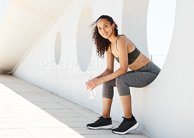 Buy stock photo Full length shot of an attractive young woman sitting alone during her outdoor workout