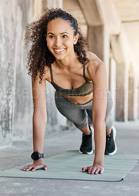 Buy stock photo Full length shot of an attractive young woman doing pushups during her outdoor workout in the city