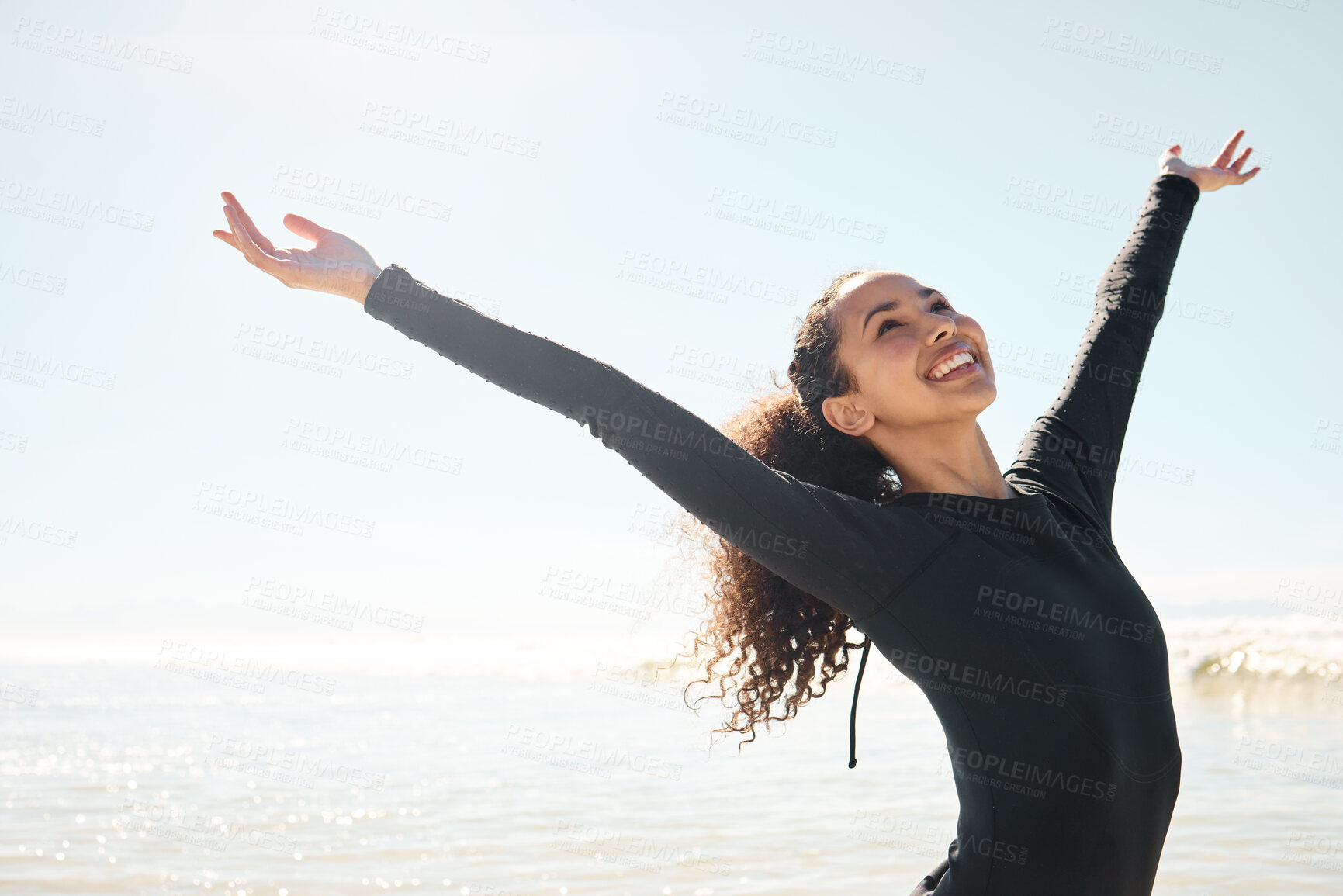 Buy stock photo Shot of a young woman celebrating on the beach