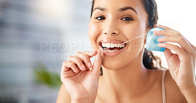 Buy stock photo Shot of a young woman flossing her teeth at home