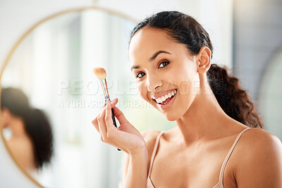 Buy stock photo Shot of a young woman applying makeup at home