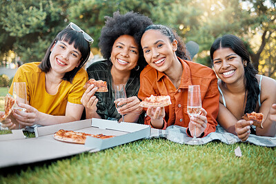 Buy stock photo Shot of a group of friends having champagne and pizza in a park