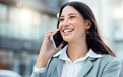 Buy stock photo Shot of a young businesswoman using a smartphone against an urban background