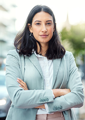 Buy stock photo Portrait of a confident young businesswoman standing against an urban background